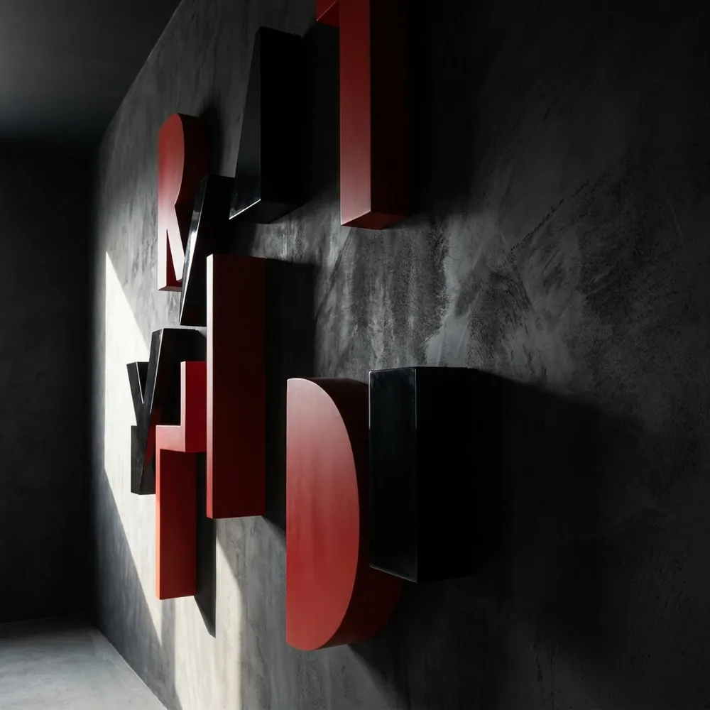 Three-dimensional fibreglass lettering on a dark wall